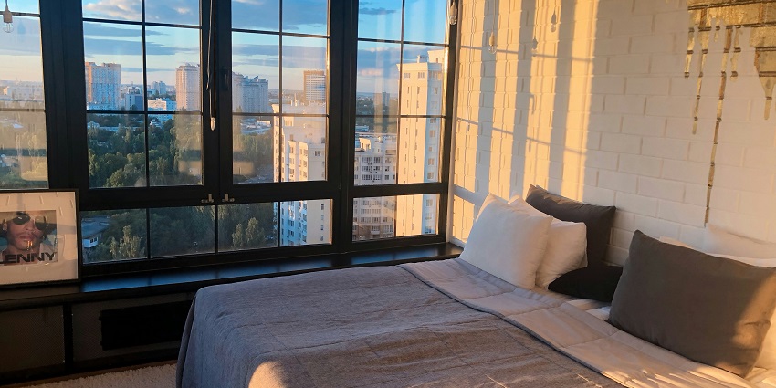 An image of the hotel room featuring a double bed along with other amenities.