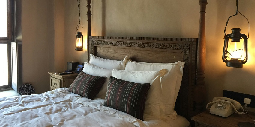 A lavish executive suite room with a view of a river from a glass window