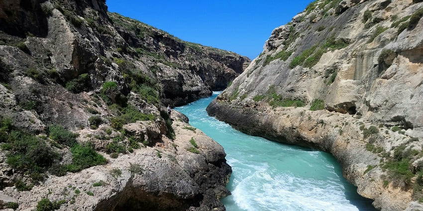 Pristine water in a narrow channel in Wied il-Ghasri Valley on Gonzo Island in Malta.