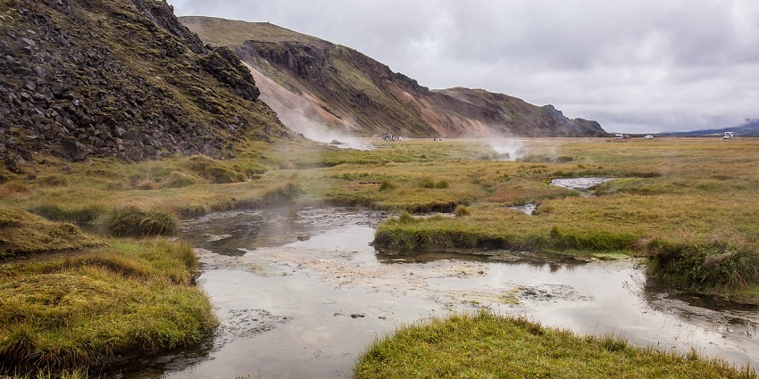 An image of a calm valley with hot springs, lush green grass, to celebrate valentines day in the USA.
