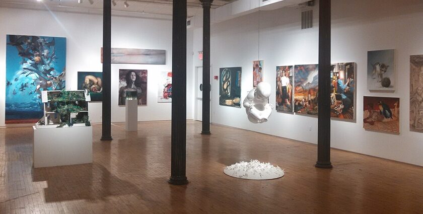 A picture of an Art Gallery in New York showcasing an exhibition on white walls.