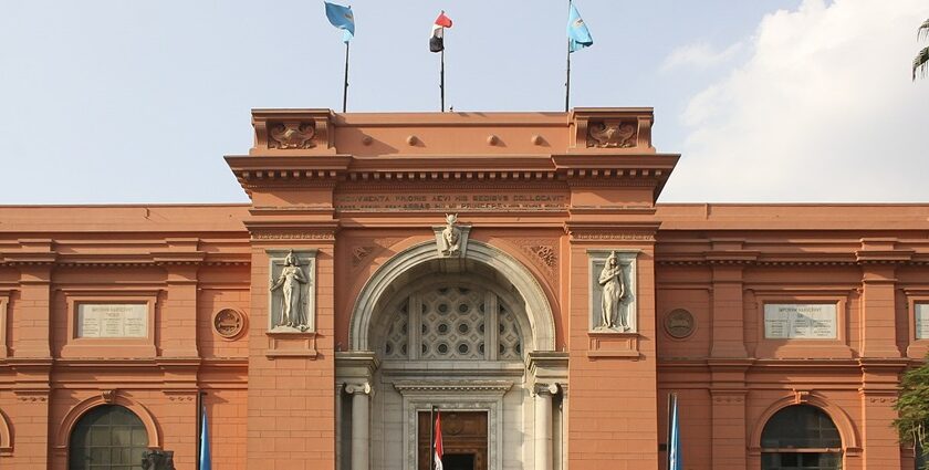 An outside view of the Egyptian Museum showcasing a few carved sculptures on its gate