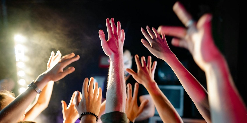 A simple image of people on the dance floor, creating a lively atmosphere with vibrant lights and good music.