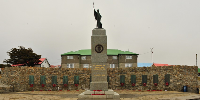 A picture of a war memorial, honouring Falklands War heroes with solemn tributes.