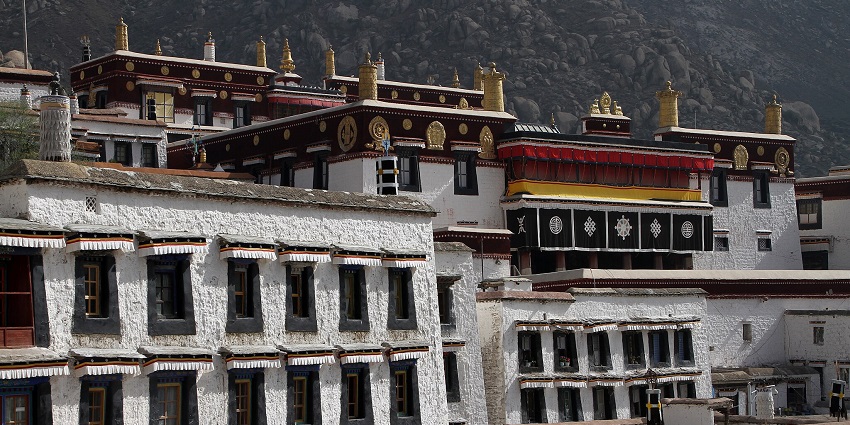 White buildings of the Drepung Monastery, displaying the side view.