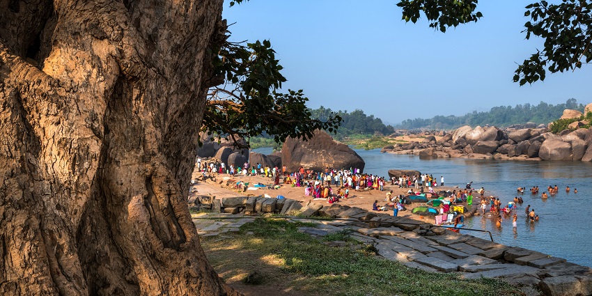 Image of People bathing and getting ready on the banks of river