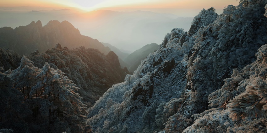 Image of Majestic Winter Sunrise Over Snowy Mountains