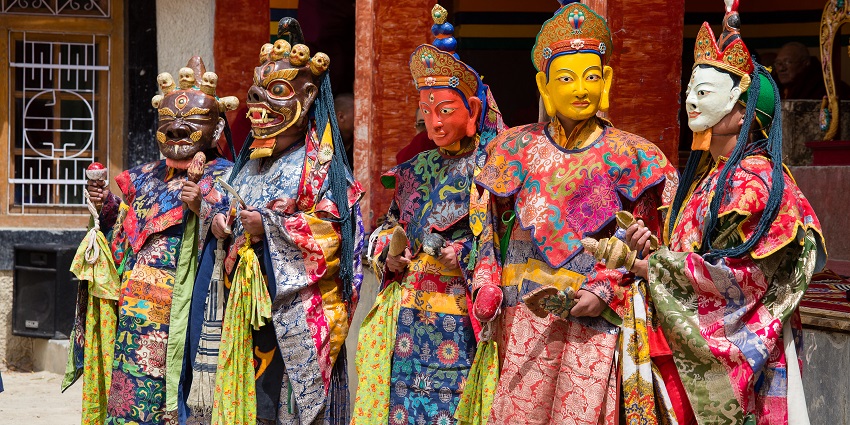 buddhist lamas dressed in mystical mask dancing Tsam mystery dance
