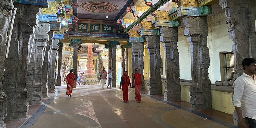 Several devotees walking inside the Adi Kumbeswarar Temple, near Patteeswaram Temple