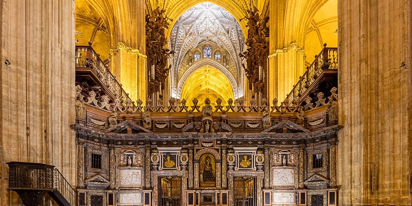 Visitors admire the Gothic Artwork At Seville Cathedral, a top thing to do in Seville