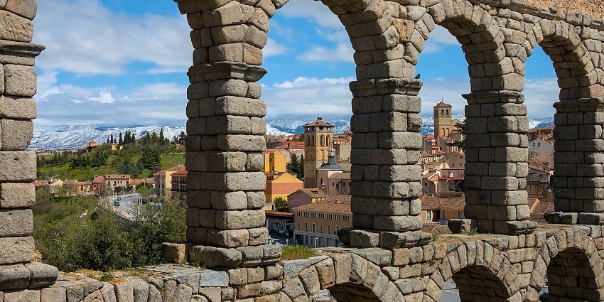 The towering granite arches of the Segovia Aqueduct glowing in the golden light of a September afternoon.