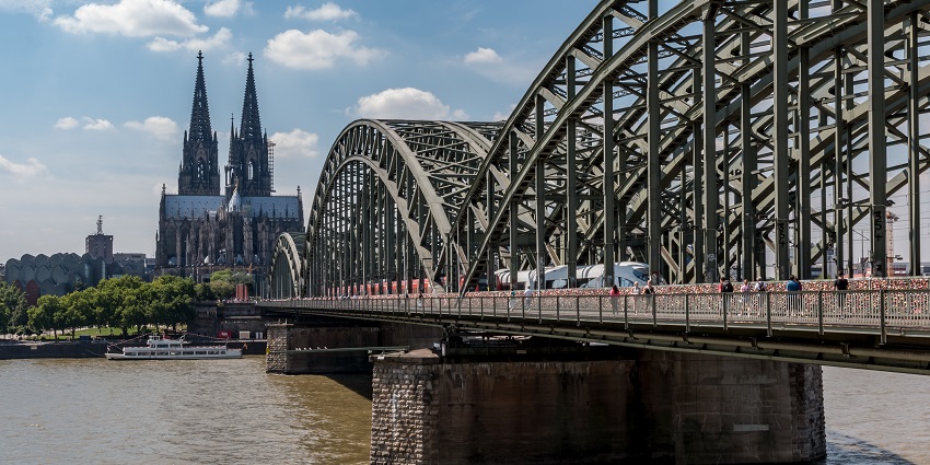 An image showing the Hohenzollernbrücke bridge in Cologne, with its iconic structure.