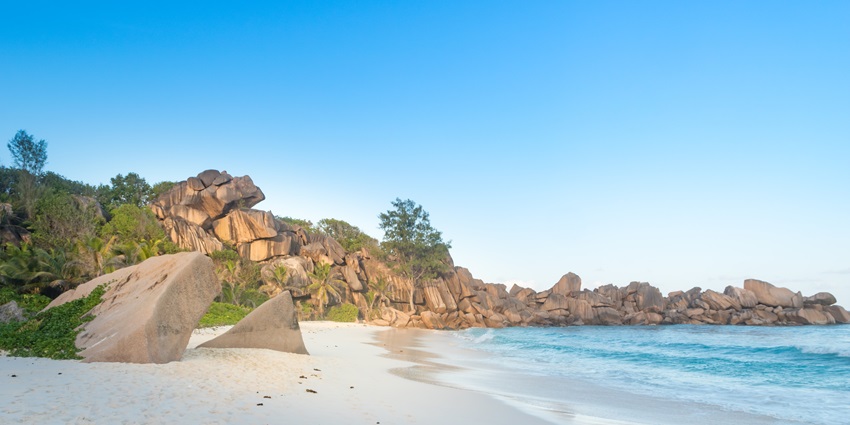 A view of azure waters and lush greenery at Romeo & Juliet Viewpoint, La Digue Island.