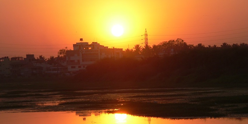 It features a beautiful sunset reflection at Agara Lake.