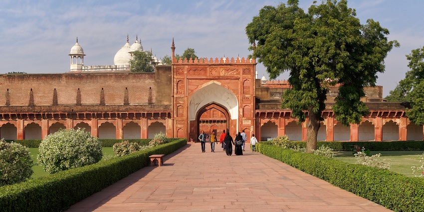 An image of the Red Fort in Agra, one of the top historical forts in India, with people and vehicles in the foreground.