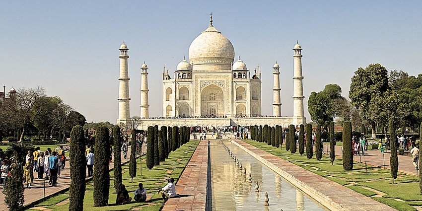 Framed view of the Taj Mahal seen through trees in Dharmapuri, Agra’s Forest Colony.