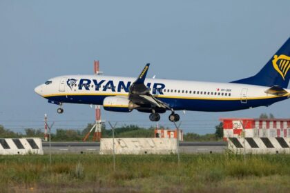 Image of a large jetlines taking off and an airplane parked at an airport in Italy