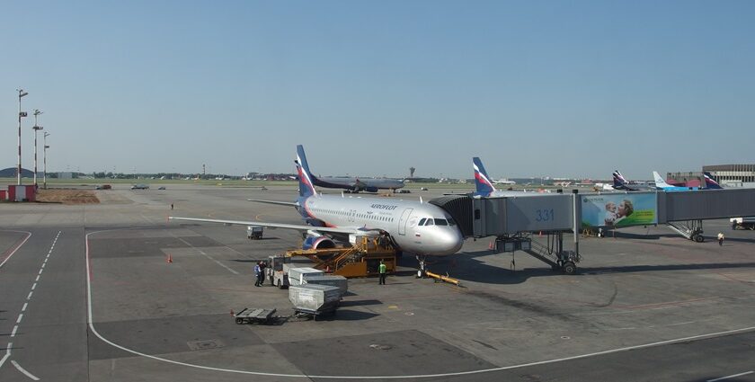 A modern airport in Russia with planes on the tarmac and a terminal in the background.