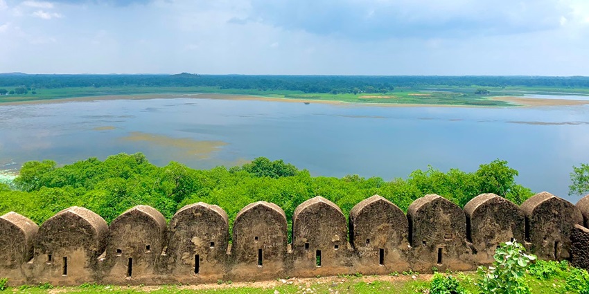A picturesque view of a wide and shallow Alambagh Lake as seen from a nearby fort.