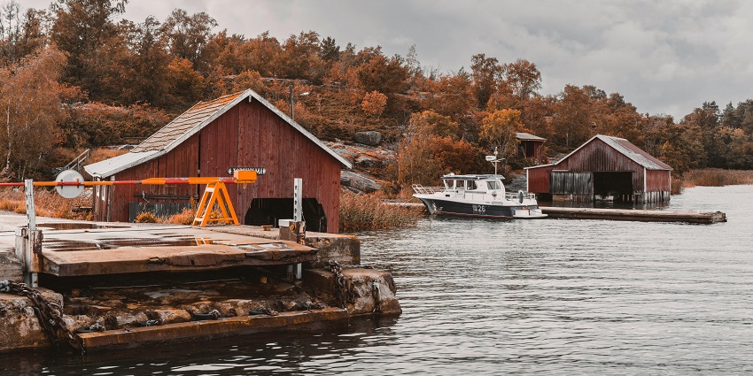 Image of the autonomous region of Finland, Åland Islands' flag on a ship against the sky.