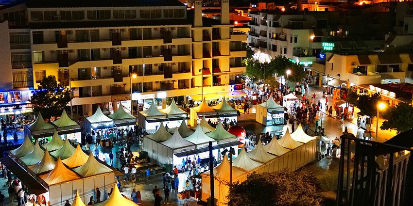 A view of people shopping at a spot in Albufeira offering the best Portugal Nightlife.