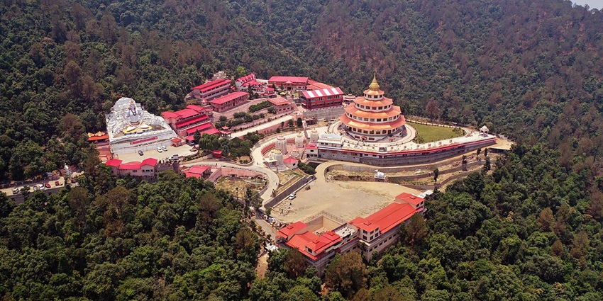 An image showing Almora Ashram Temple in Uttarakhand, surrounded by peaceful hills and dense greenery