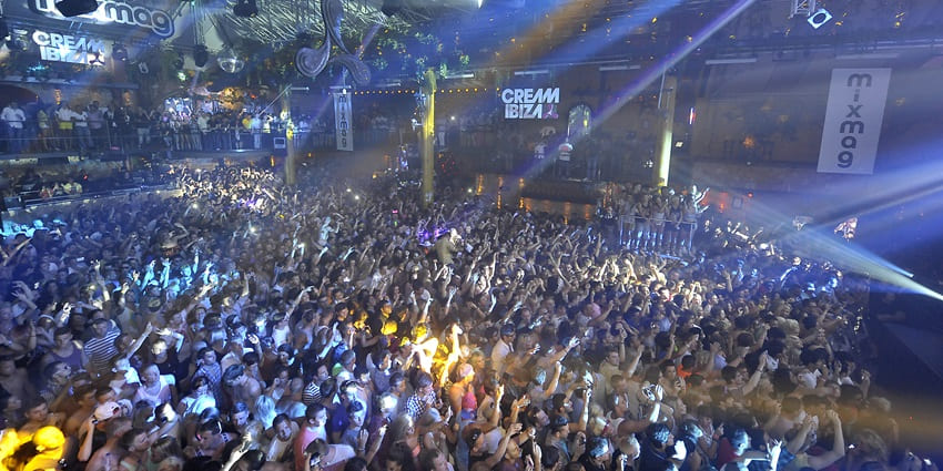 People dancing to the beats of DJ at Amnesia Ibiza enjoying Ibiza Spain nightlife magic