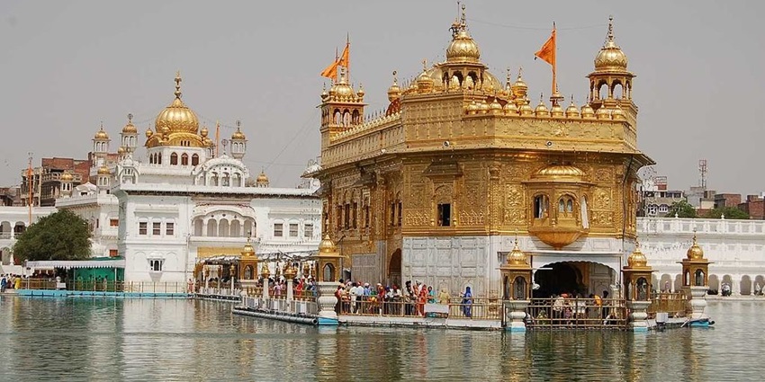 An Image of the Golden Temple in Amritsar and the temple's reflection can be seen in the water body