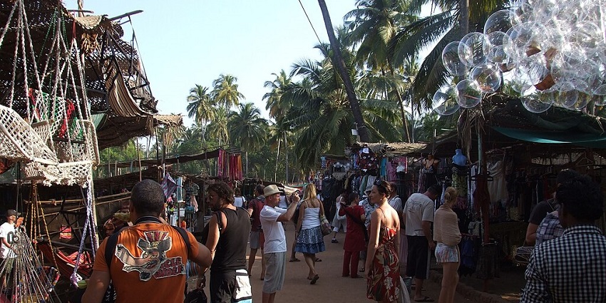 Tourists shopping for clothes and souvenirs at Anjuna Market.