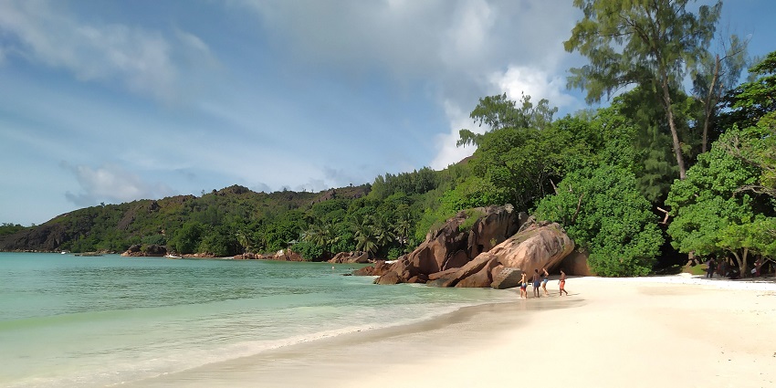 An image of Anse Volbert, a stunning white-sand beach with turquoise waters, scenic views