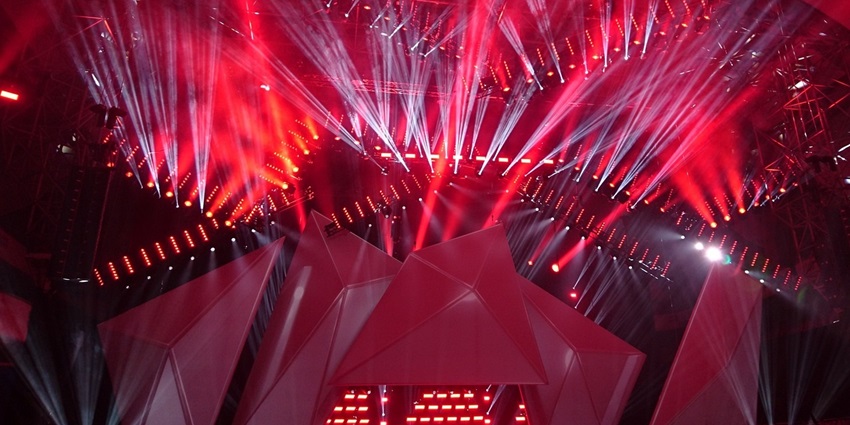 An image showing a laser disco and live concert similar to the vibrant Apollo Live Club.