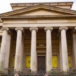 A view of the Manchester Art Gallery showcasing its grand entrance and people entering