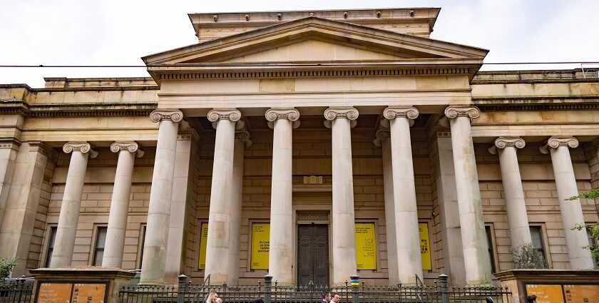 A view of the Manchester Art Gallery showcasing its grand entrance and people entering