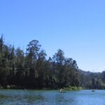 An image of the Ooty Lake shows tourists enjoying boating in the lake’s calm waters.