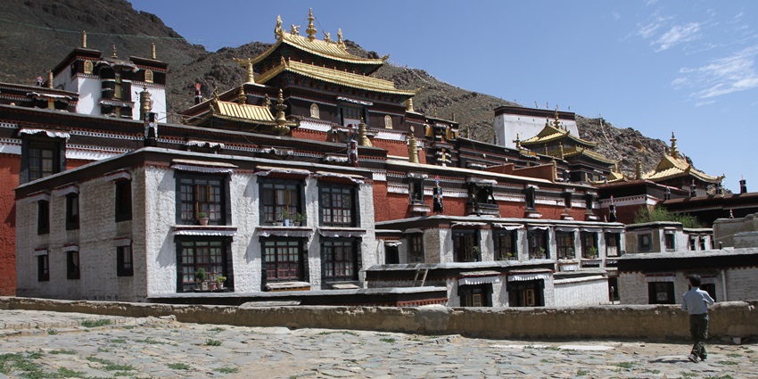 Devotees gathered in a sacred space, chanting prayers and lighting incense during a ceremony