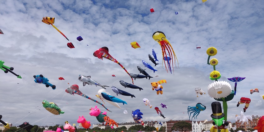A picture showing participants flying kites on rooftops during the Kite Festival, part of Uttarayan, the harvest festival of Gujarat.