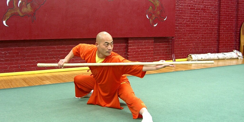 Martial artists performing a dynamic Kung Fu show with high-flying kicks and acrobatics