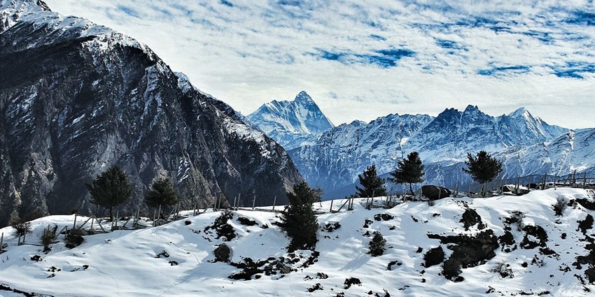 An image of Auli’s snow-covered slopes, one of the top places to visit in India, in June.