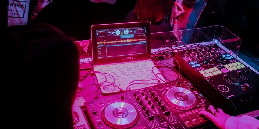 An image showing a DJ at a nightclub, resembling the lively Bergen nightlife