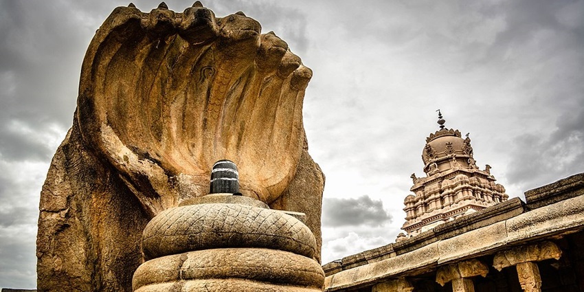 Veerabhadra temple with traditional architecture, a unique Shiva linga and a snake statue.