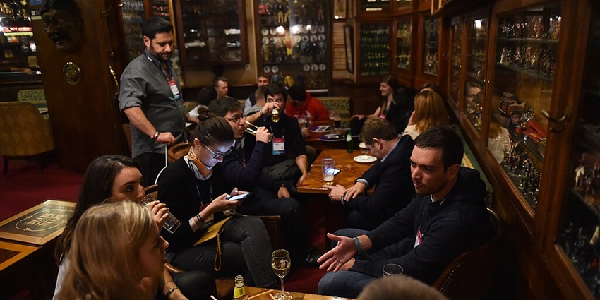 A social group enjoying drinks at Bairro Alto, a top place for vibrant Portugal nightlife.