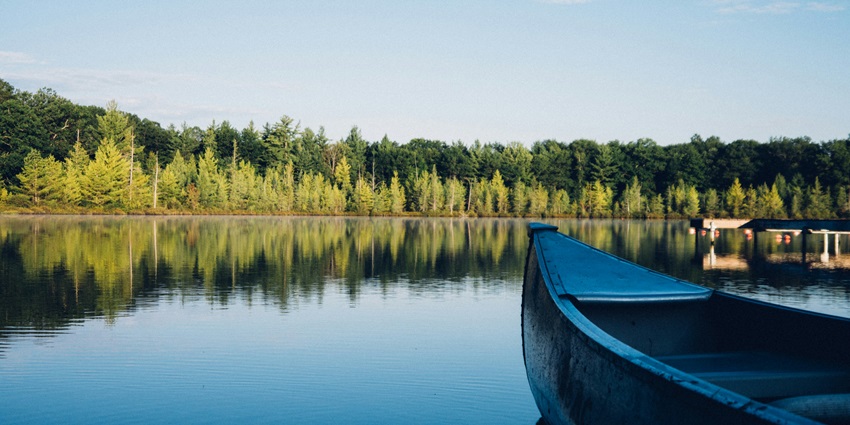 A beautiful view of one of the lakes in Wayanad Lake with houseboats and distant hills.