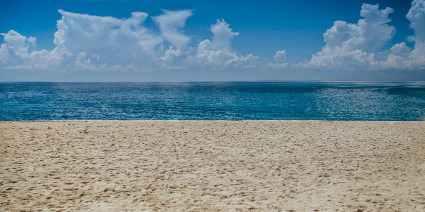 Expansive white sand beach perfect for relaxation and water activities.