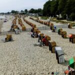 An image showing the serene beach of Kellenhusen with strandkorbs, a gem among beaches in Germany.