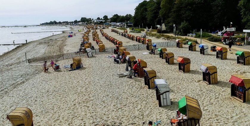 An image showing the serene beach of Kellenhusen with strandkorbs, a gem among beaches in Germany.