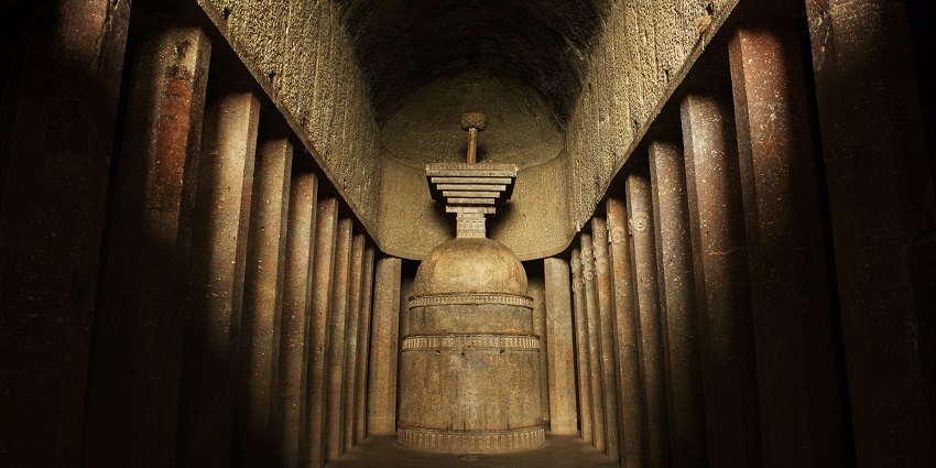 An image of an ancient stone structure with columns and a central stupa inside the Bedse cave