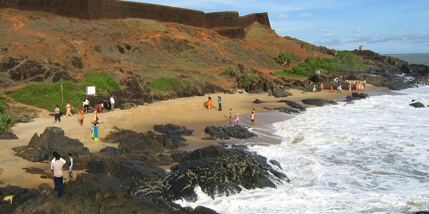 Crystal-clear water and lush green trees at the beaches in South India