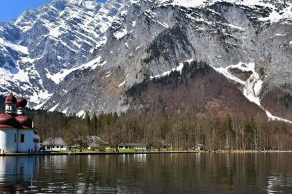 An image showing the stunning Königssee in Berchtesgaden National Park, Germany, surrounded by mountains.