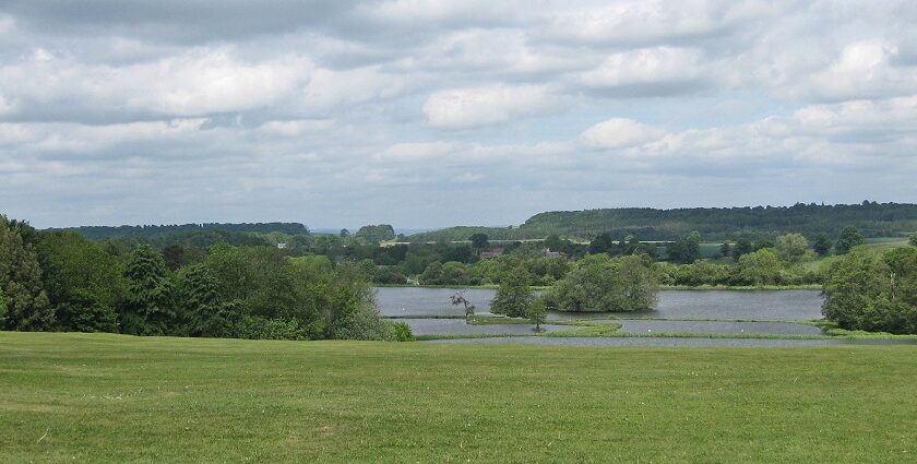 View of the Great Lake of the UK showing clear waters, small trees in between and green grass around