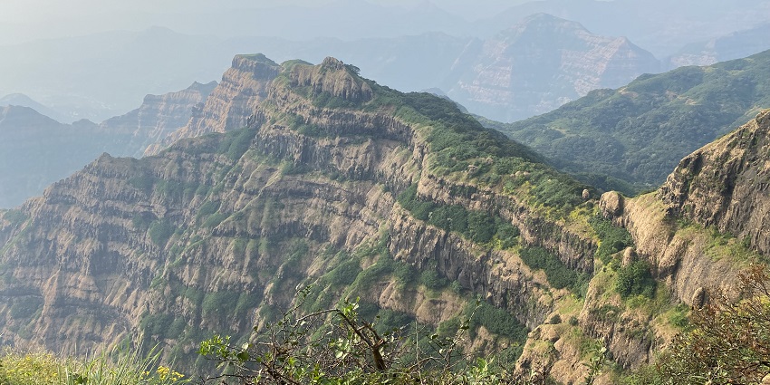 The panoramic view from the hill station with lush green forest cover hills during day time